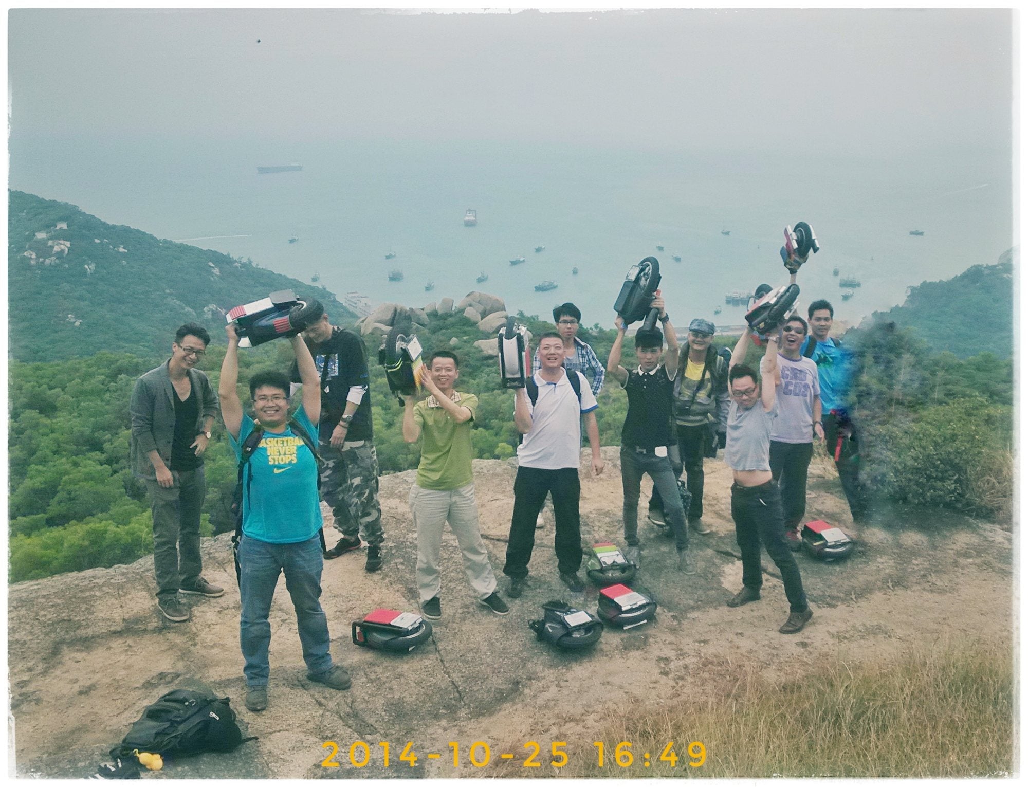 Begode community riders holding early electric unicycles on a mountain in 2014